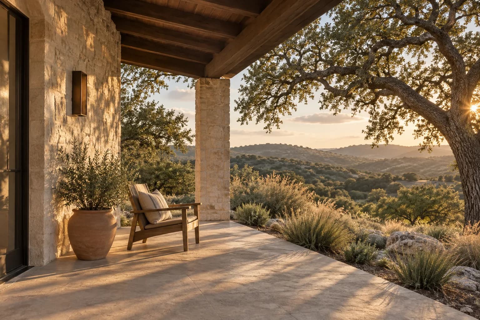 Illustrative limestone porch opening toward live oaks and rolling hills